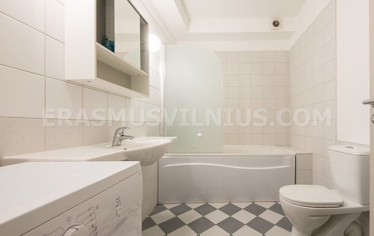Bathroom with bathtub, shower and washing machine in Erasmus Vilnius Flat 2