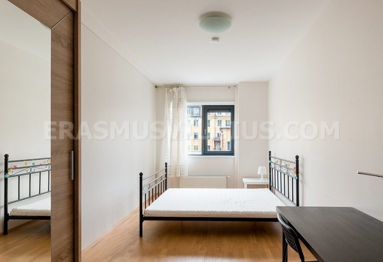 Furnished bedroom with king size bed, desk and wardrobe in Erasmus student flat Vilnius