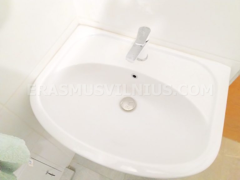 Bedroom with warm evening light through skylight window