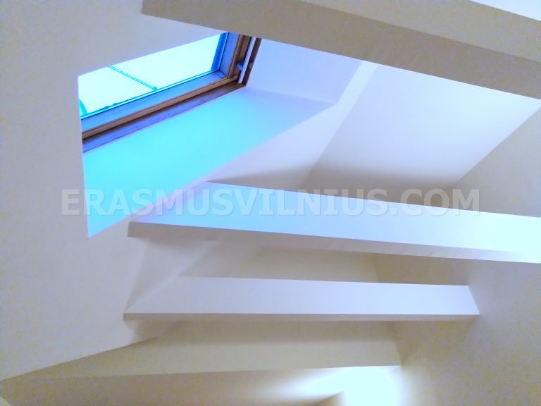 Bedroom in warm evening light with cosy attic atmosphere