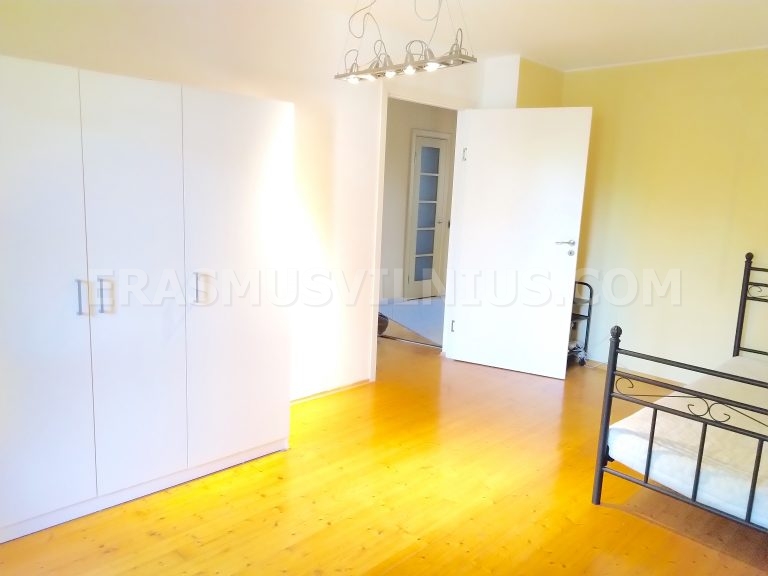 Furnished bedroom with wardrobe in Vilnius old town flat