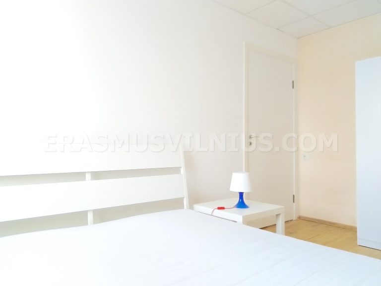 Furnished bedroom with desk, wardrobe and lamp in Erasmus Vilnius Flat 3
